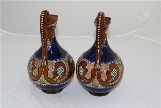 A pair of Doulton Lambeth Art Nouveau stoneware ewers, by Frank A Butler, c.1900, height 24cm (9.5in.)